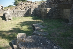 North end of the stoa between the monumental center and agora.