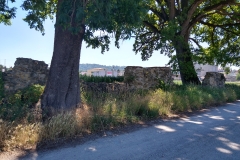 Western extent of the city walls along Chemin Derrière les Murs, near the intersection with Route de l\'Estivage.