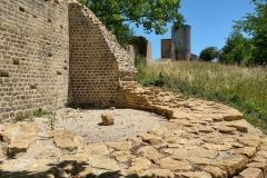 Base of one of the towers  near the east gate, with the Tornallaz in the background.