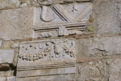 Spolia in the east wall of the Rocca dei Rettori.