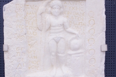 Funerary stele for the gladiator Poplius, also known as Mariskos Arpeinos, who suffered much, but did not die in combat, but rather in an accident. Dedicated by Alexandra. Dated to the late 2nd century CE. Wall of Memory at the Archaeological Museum of Veria.