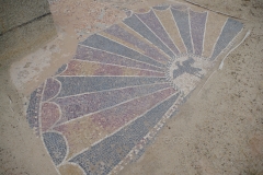 Mosaic at the entrance of the western apodyterium of the Los Arcos I baths.